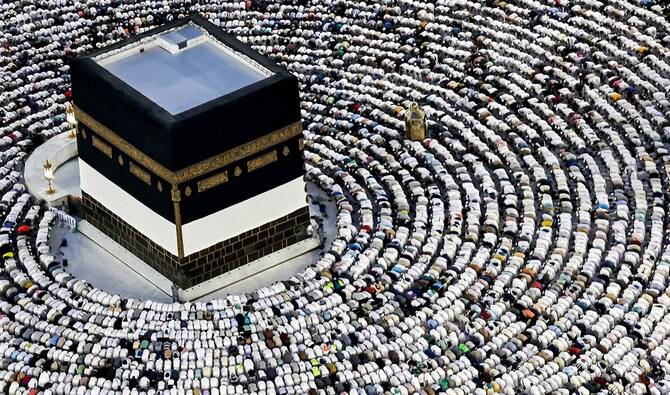 Muslim pilgrims pray around the Kaaba, Islam's holiest shrine, at the Grand Mosque in the holy city of Mecca on June 16, 2024, as they perform the farewell circumambulation or "tawaf", circling seven times around the large black cube, which is the focal point on the final day of the hajj. (AFP/File)