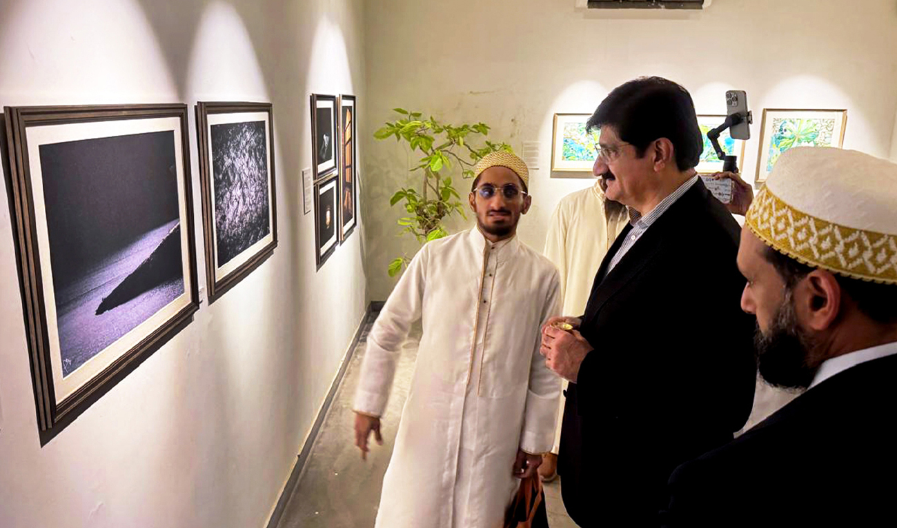 Sindh Chief Minister Syed Murad Ali Shah (center) looks at an Islamic spiritual artwork during the inauguration of the “Light Upon Light” exhibition at Keol Art Gallery in Karachi, Pakistan, on November 18, 2025. (CM Sindh Office)