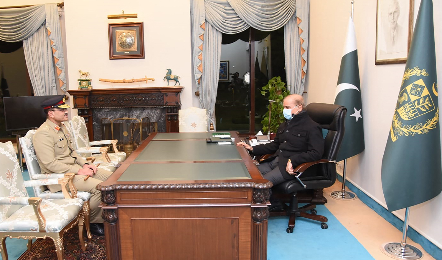 This handout picture taken and released by Pakistan Prime Minister's Office on November 24, 2022, shows Pakistan's Prime Minister Shehbaz Sharif (R) meets with the nomination of the next Pakistan's army Chief General Syed Asim Munir (L) at the Prime Minister House in Islamabad. (AFP/File)