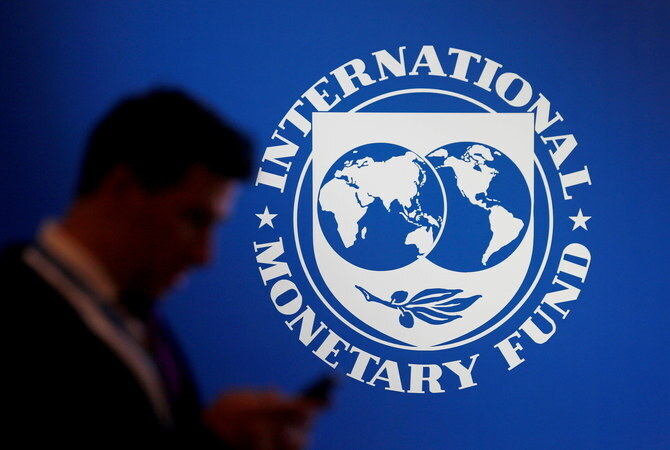 A man stands near a logo of IMF at the International Monetary Fund — World Bank Annual Meeting 2018 in Nusa Dua, Bali, Indonesia, on October 12, 2018. (REUTERS/File)