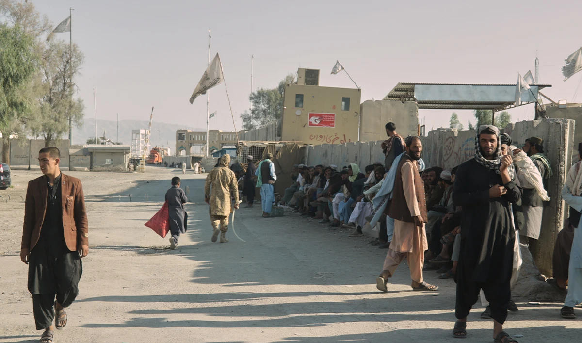 People wait near the closed gate at the Spin Boldak border crossing with Pakistan, after the border was shut for nearly two weeks following clashes between Afghan and Pakistani forces, in Kandahar province, Afghanistan, on October 23, 2025. (AP/File)