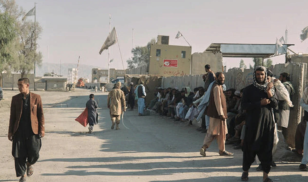 People wait near the closed gate at the Spin Boldak border crossing with Pakistan, after the border was shut for nearly two weeks following clashes between Afghan and Pakistani forces, in Kandahar province, Afghanistan, on October 23, 2025. (AP/File)