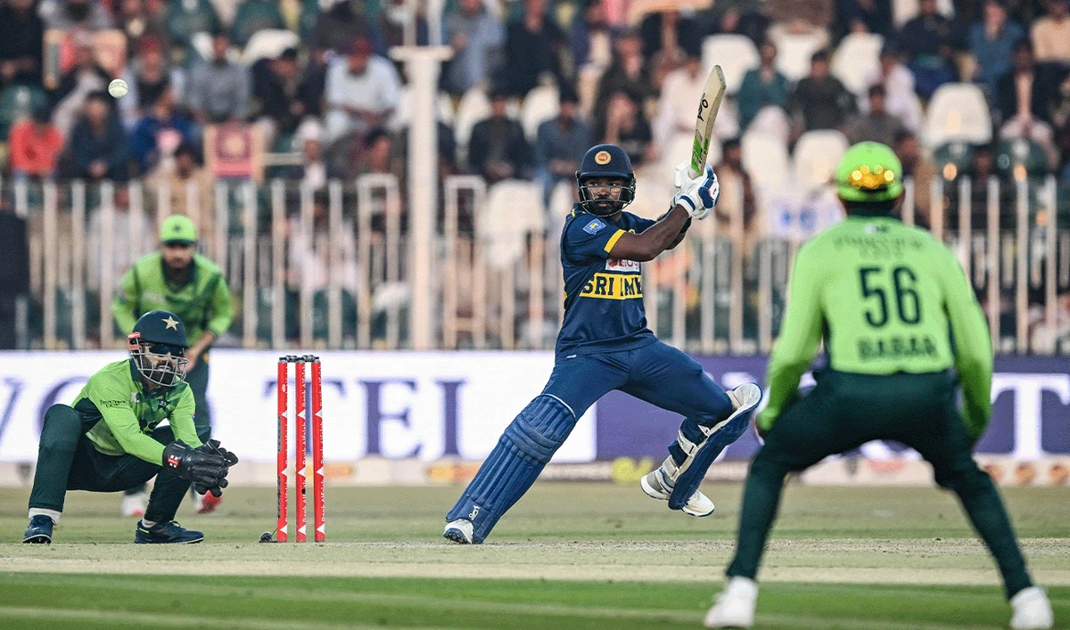 Sri Lanka's Janith Liyanage (center) plays a shot during the second one-day international (ODI) cricket match between Pakistan and Sri Lanka at the Rawalpindi Cricket Stadium in Rawalpindi on November 14, 2025. (AFP)