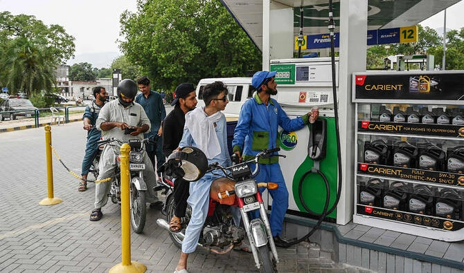 An employee fills the tank of a motorbike at a fuel station in Islamabad, Pakistan, on June 16, 2025. (AFP/File)