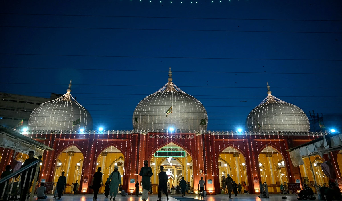Sunni Muslims walk past the New Memon Mosque illuminated ahead of Eid-e-Milad-un-Nabi, which commemorates the birth anniversary of Prophet Mohammed in Karachi on September 4, 2025. (AFP/File)