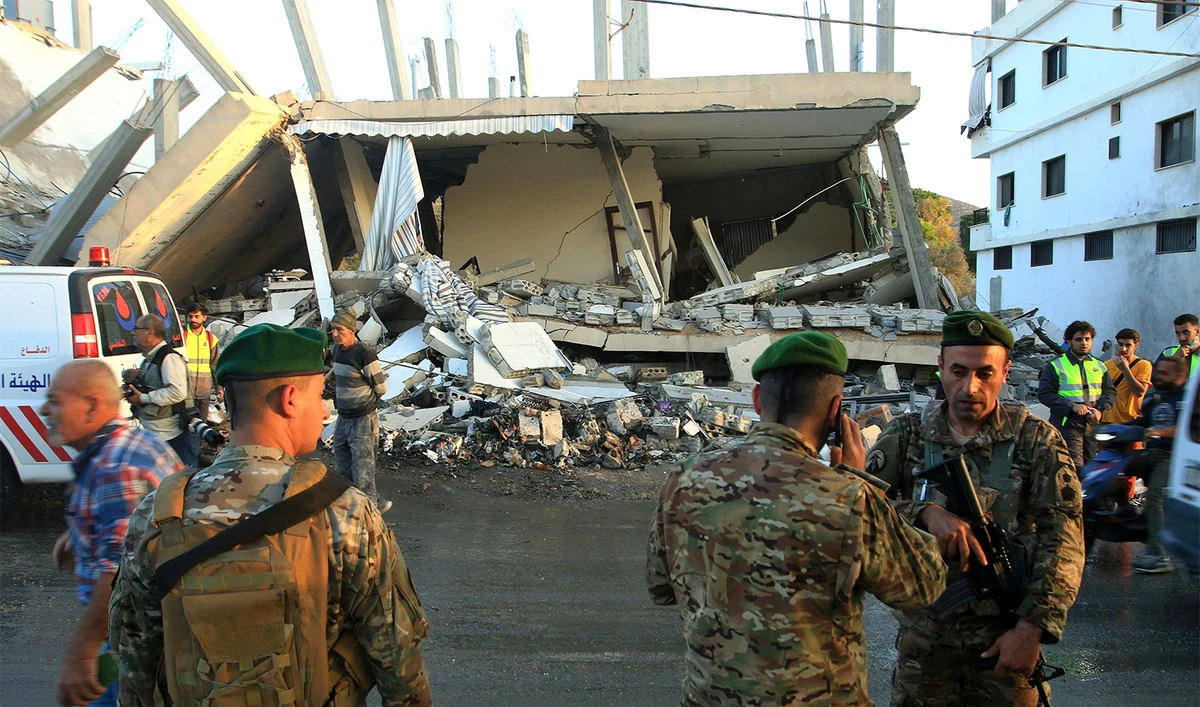 Lebanese army soldiers secure the site of an Israeli airstrike that targeted a building in the southern Lebanese village of Deir Kifa on November 19, 2025. (AFP/File)