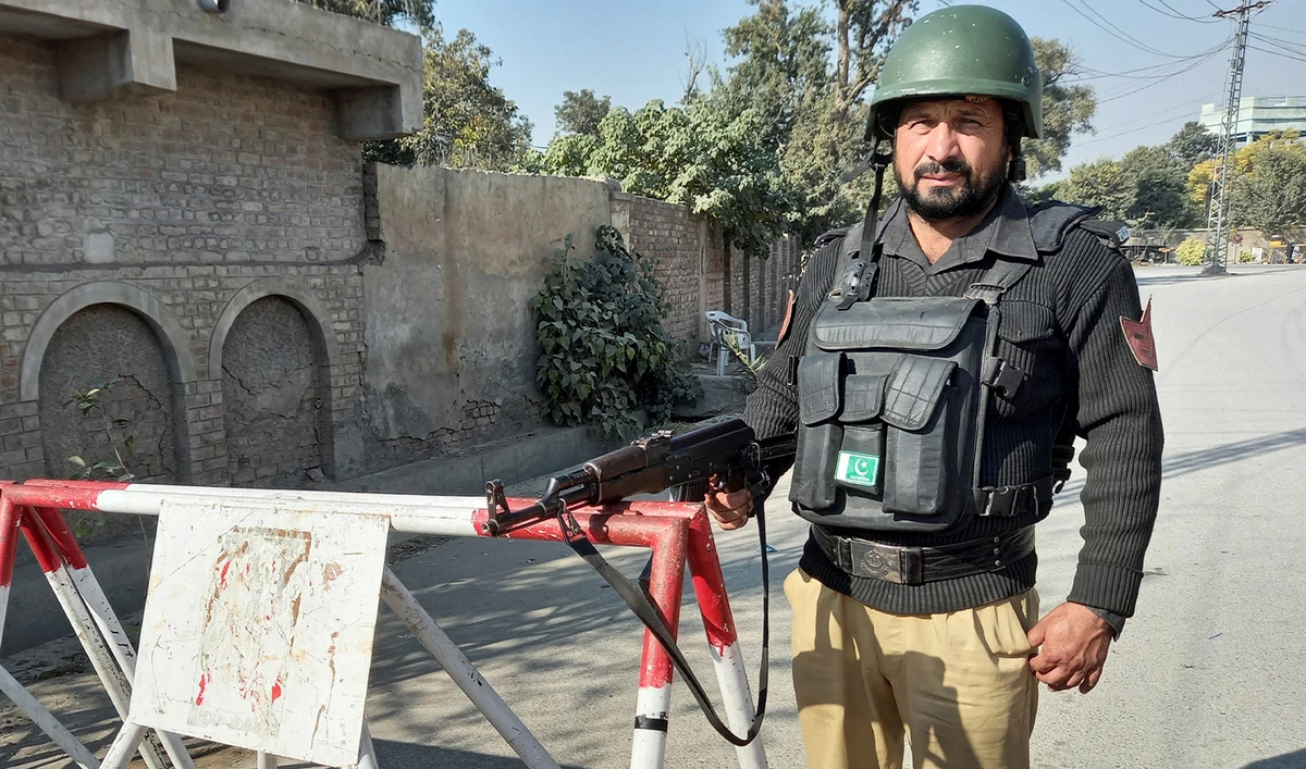 A police officer stands guard on a road leading to the cantonment area in Bannu, Pakistan, on December 21, 2022. (REUTERS/File)