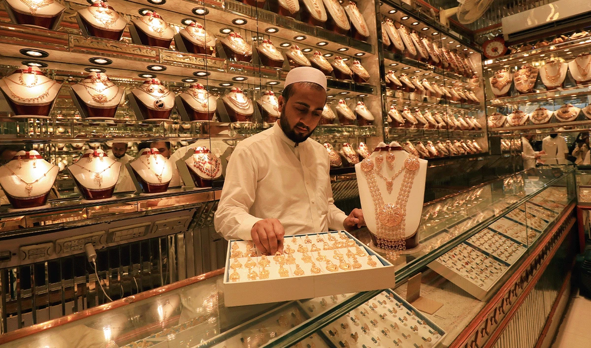 A shopkeeper arranges a box of earrings while showing to a customer (not pictured) at a gold shop in Peshawar, Pakistan August 6, 2020. (reuters/File)