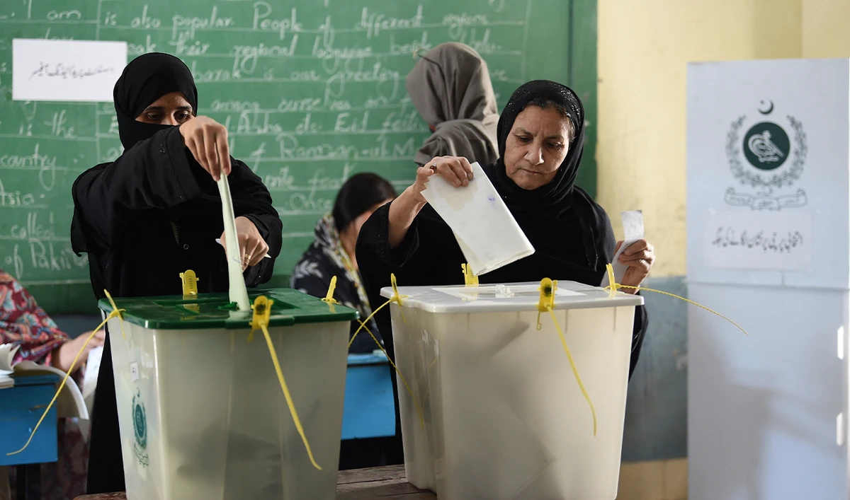 Women cast their ballots to vote at a polling station during Pakistan’s national elections in Karachi on February 8, 2024. (AFP/File)