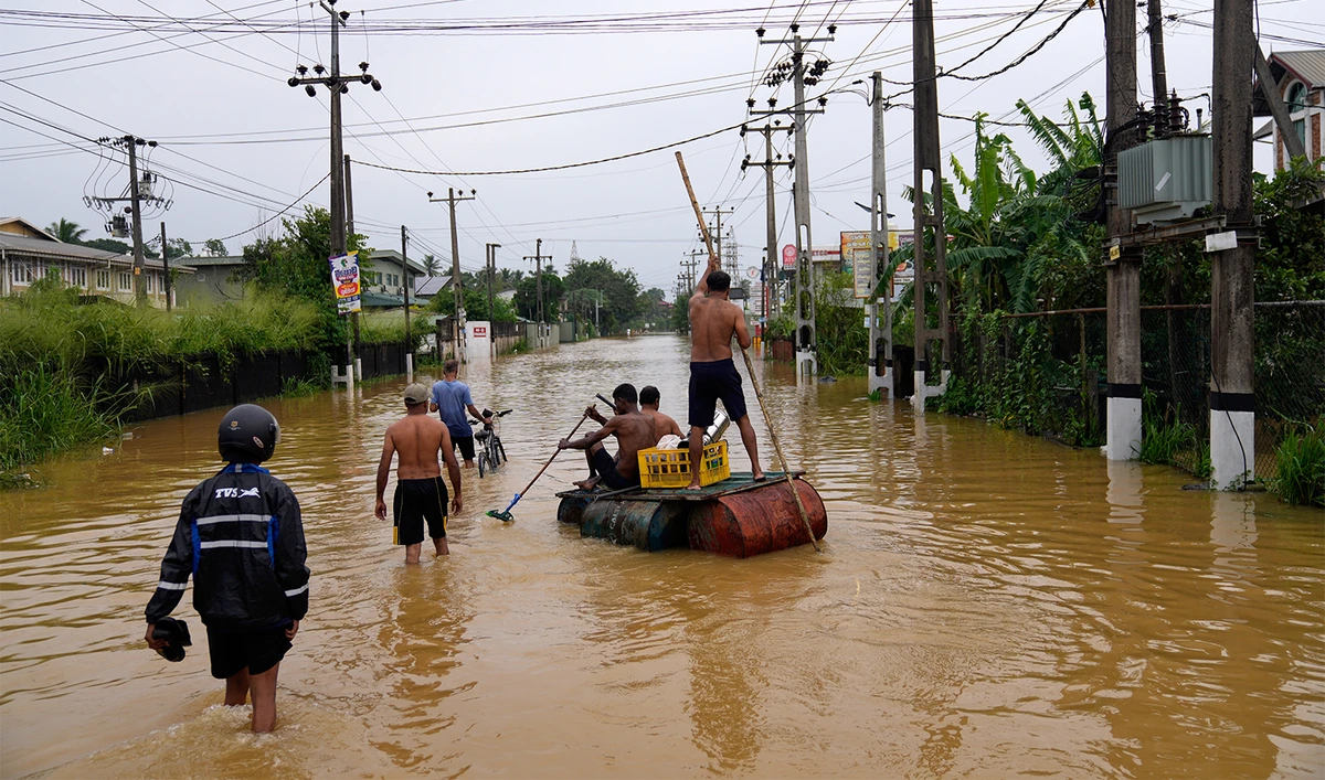 People use a crude raft to navigate a flooded street in Colombo, Sri Lanka, on Nov. 29, 2025. (AP)