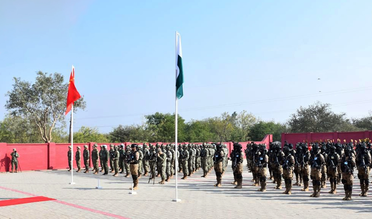 The handout photograph released on December 1, 2025, shows soldiers of the Pakistan Army and People’s Liberation Army (PLA) of China attending the opening ceremony of joint military exercise Warrior-IX at the National Counter Terrorism Center (NCTC), Pabbi, in Nowshera, Pakistan. (ISPR)