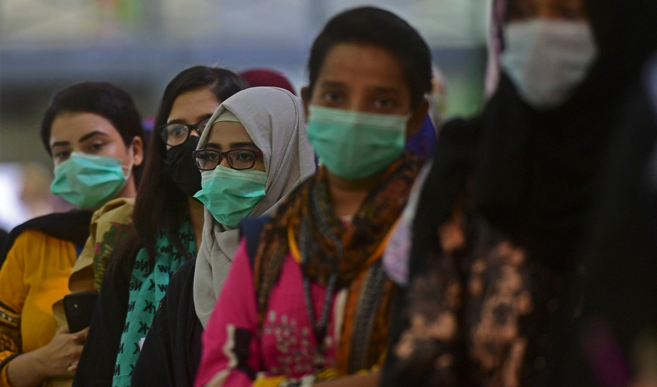 Women wait for their turn to receive a dose of the Covid-19 coronavirus Sinovac vaccine at a vaccination camp organised at expo centre in Karachi on June 3, 2021. (AFP/File)