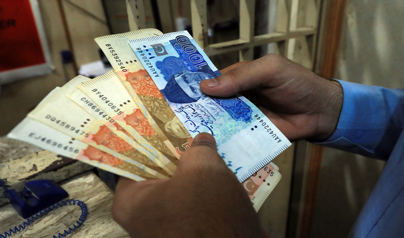 A man counts Pakistani rupee notes at a currency exchange shop in Peshawar, Pakistan, on September 12, 2023. (REUTERS/File)