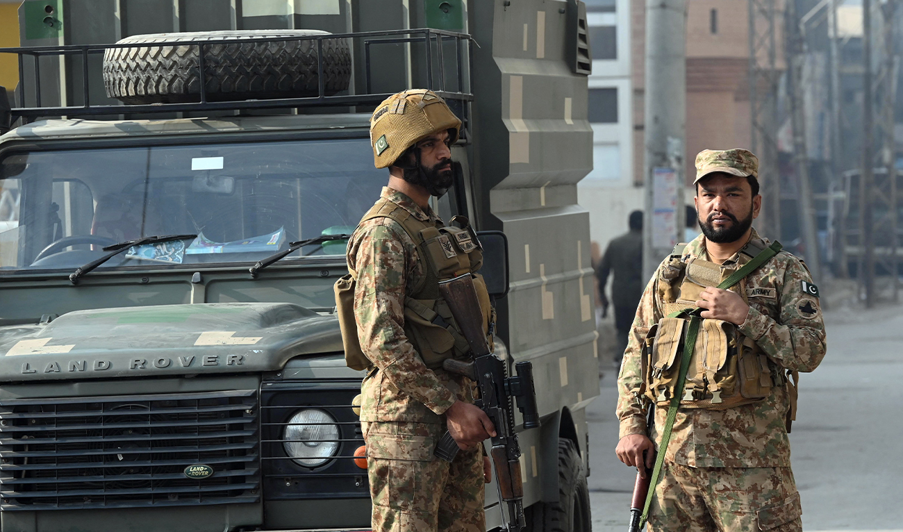 Security personnel stand guard at the site of a suicide attack outside the border force headquarters in Peshawar, Pakistan, on November 24, 2025. (AFP/File)