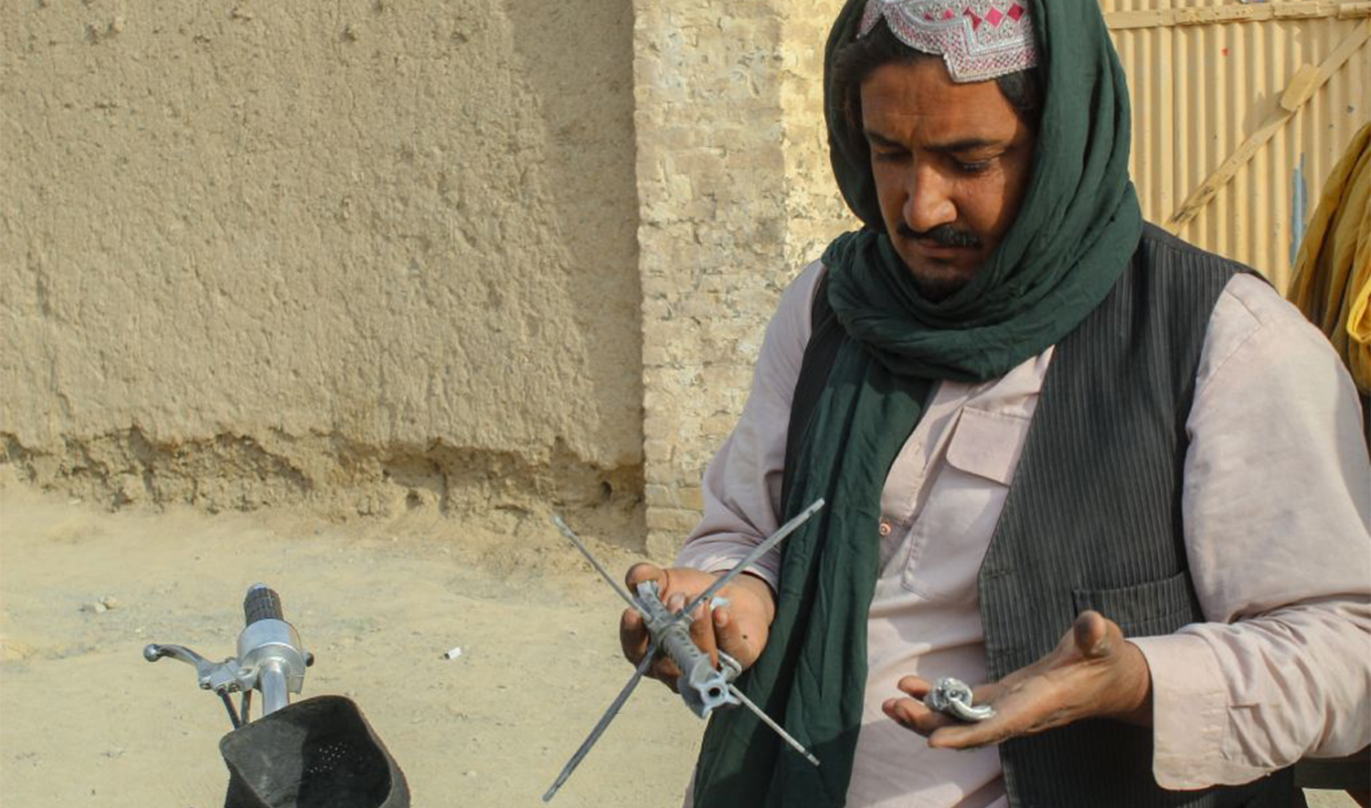 A man shows fragments of a fired mortar outside a damaged house in Chaman on December 6, 2025, following overnight cross-border fire between Pakistan and Afghanistan. (Reuters)