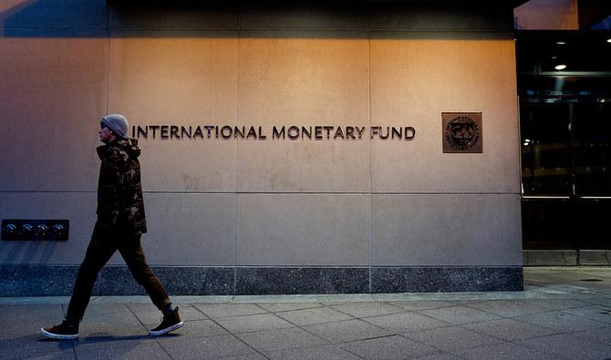 A pedestrian walks past the International Monetary Fund (IMF) headquarters in Washington DC, United States on January 10, 2022. (AFP/File)