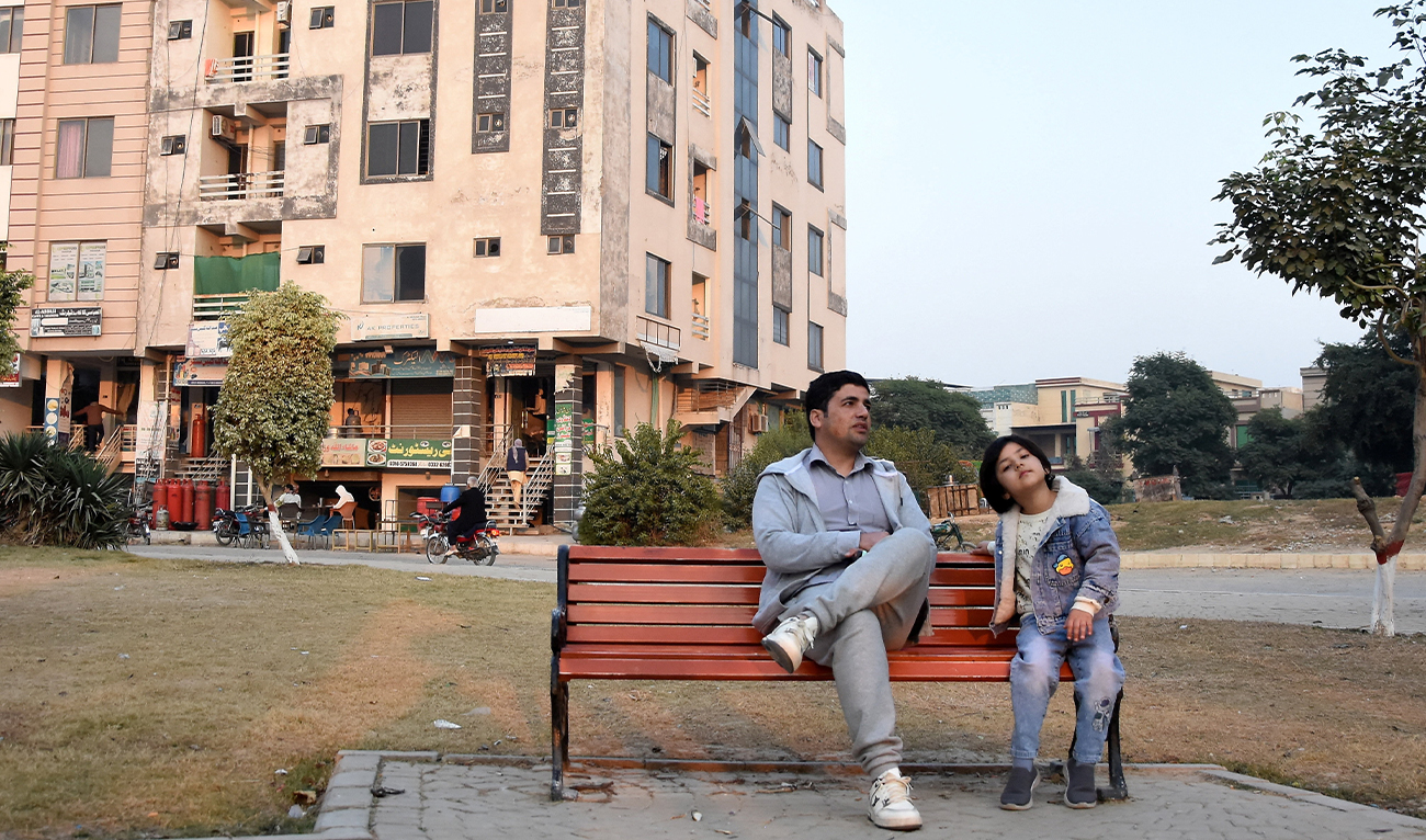Ahmad Samim Naimi from Afghanistan’s Panjshir province, who had worked as a TV presenter and press adviser, sits with his daughter Arya Naimi (right) after the US halted visa processing for Afghan nationals, in Islamabad, Pakistan, on November 28, 2025. (REUTERS/File)