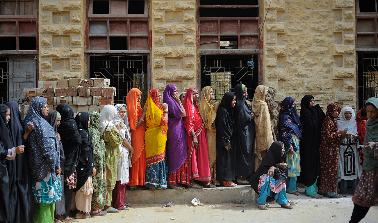 Women line up to receive money from a charity organization, Benazir Income Support Program, at an assistance center setup at a local school building in Karachi on March 5, 2012. (REUTERS/ file)