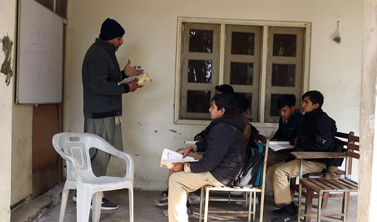 The screengrab taken from a video shows students attending a class at Qadar Nagar High School in Buner district of Khyber Pakhtunkhwa province, Pakistan. (Screengrab/AN)