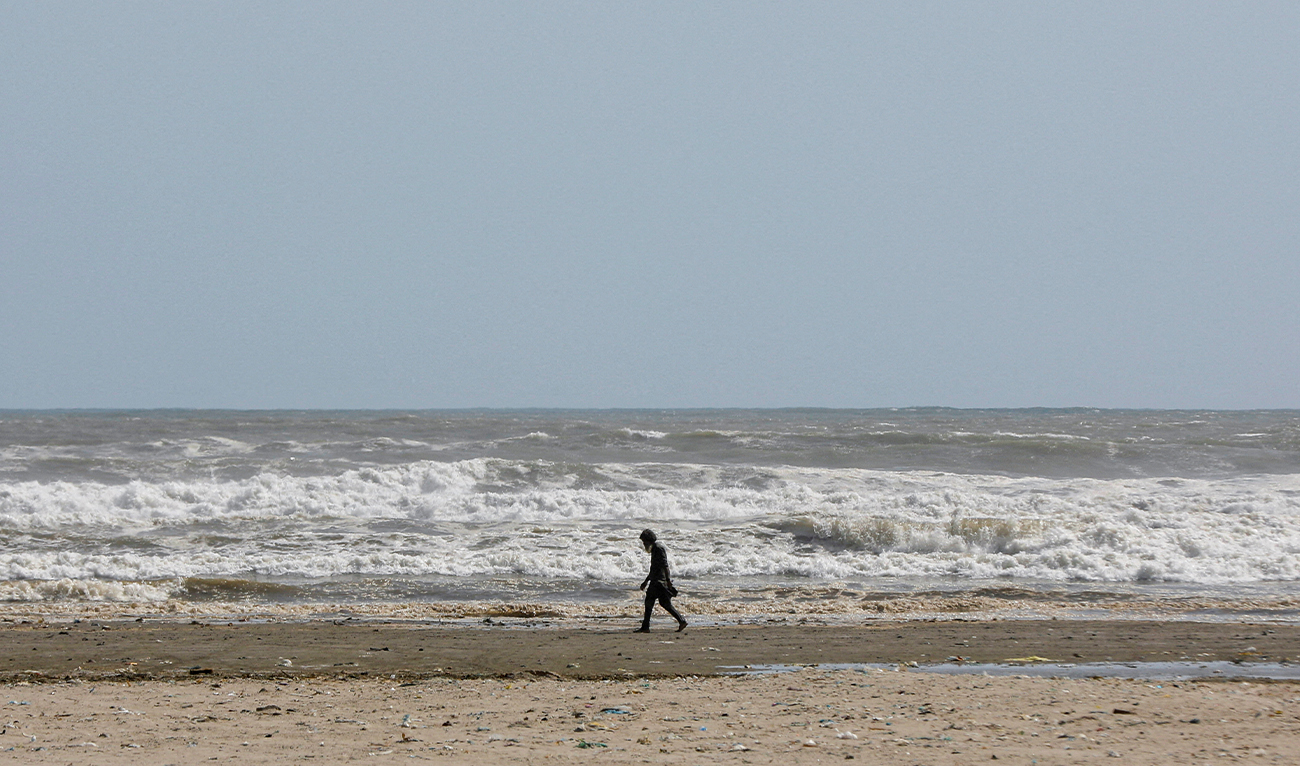 A man walks along Clifton beach in Karachi, Pakistan, on June 12, 2023. (REUTERS/File)