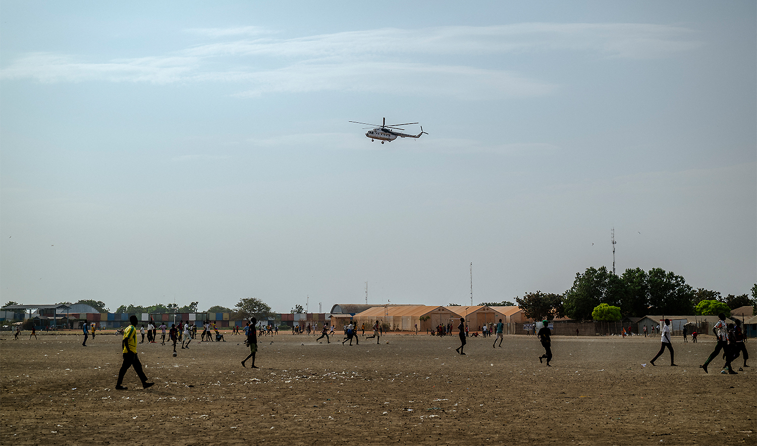 A UN helicopter performs a routine patrol over the Bentiu internally displaced persons camp in Unity State, South Sudan, on November 4, 2025. (AFP)