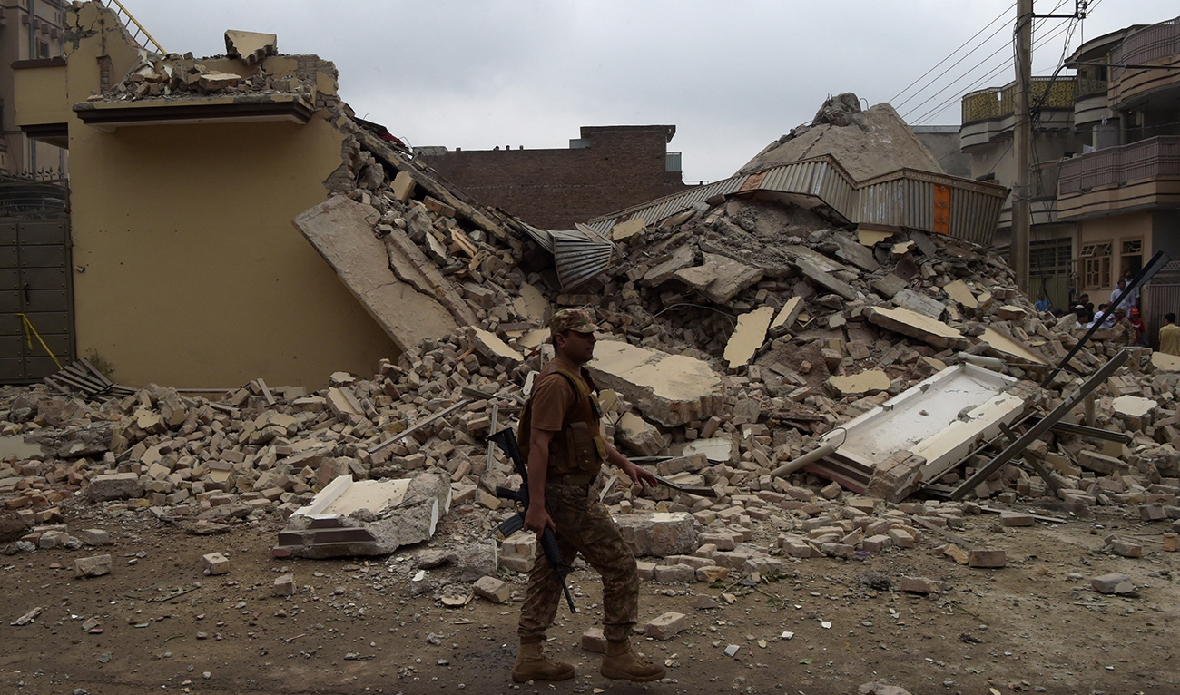 A Pakistani soldier walks past a demolished hideout of suspected militants during an operation in Peshawar on April 16, 2019. (AFP/ file)