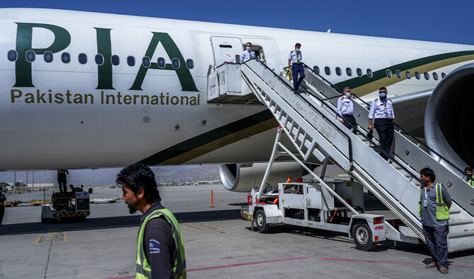 Crew members disembark from a Pakistan International Airlines (PIA) flight after it lands at the Kabul International Airport in Kabul, Afghanistan, on September 13, 2021. (AFP/File)