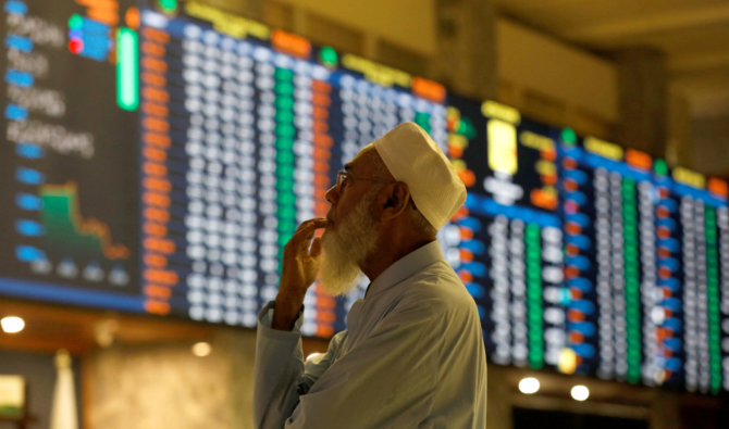 A stock broker reacts while monitoring the market on the electronic board displaying share prices during trading session at the Pakistan Stock Exchange, in Karachi, Pakistan July 3, 2023. (REUTERS)