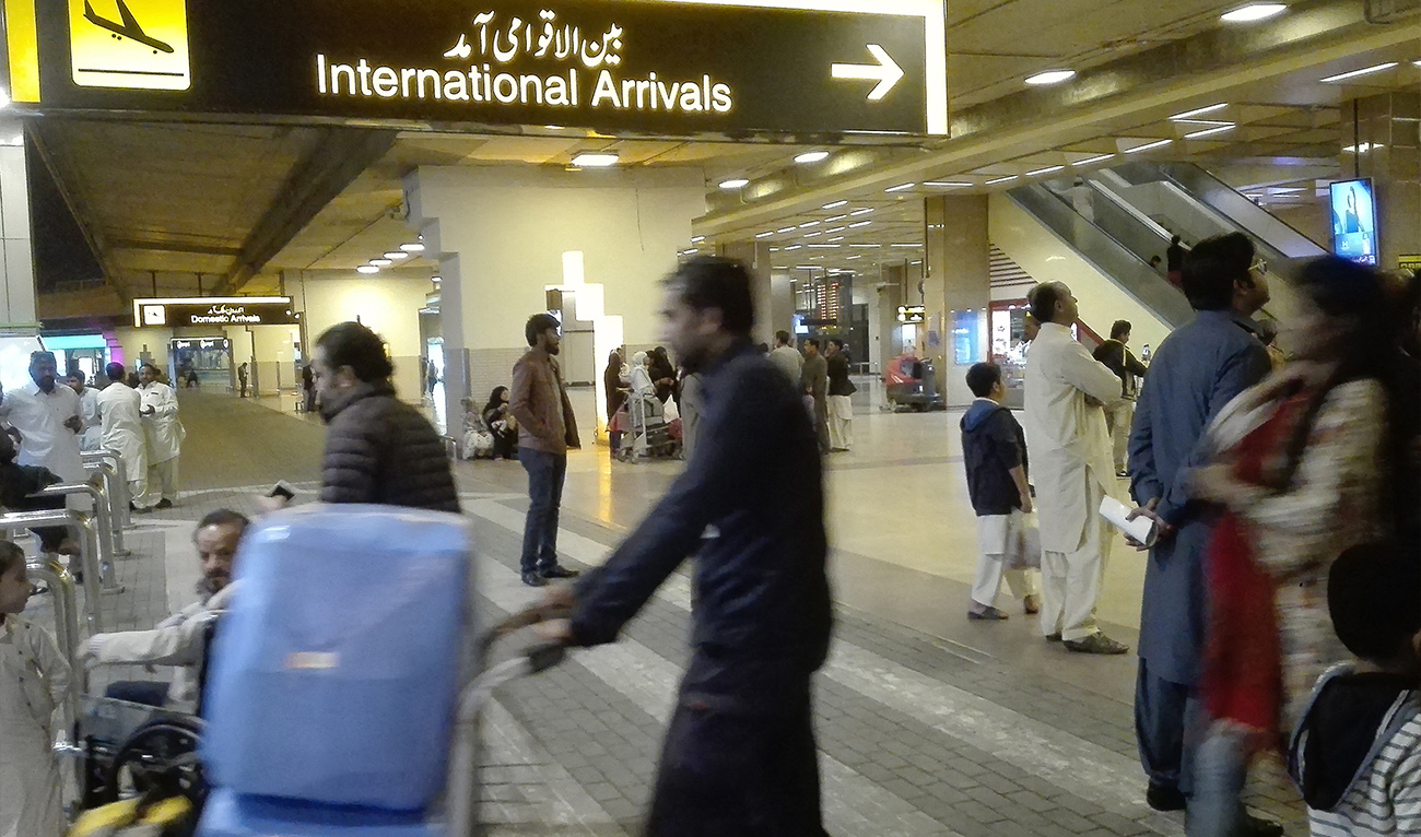 Passengers walk after their arrival at the Jinnah International Airport in Karachi on January 31, 2020. (AFP/ file)