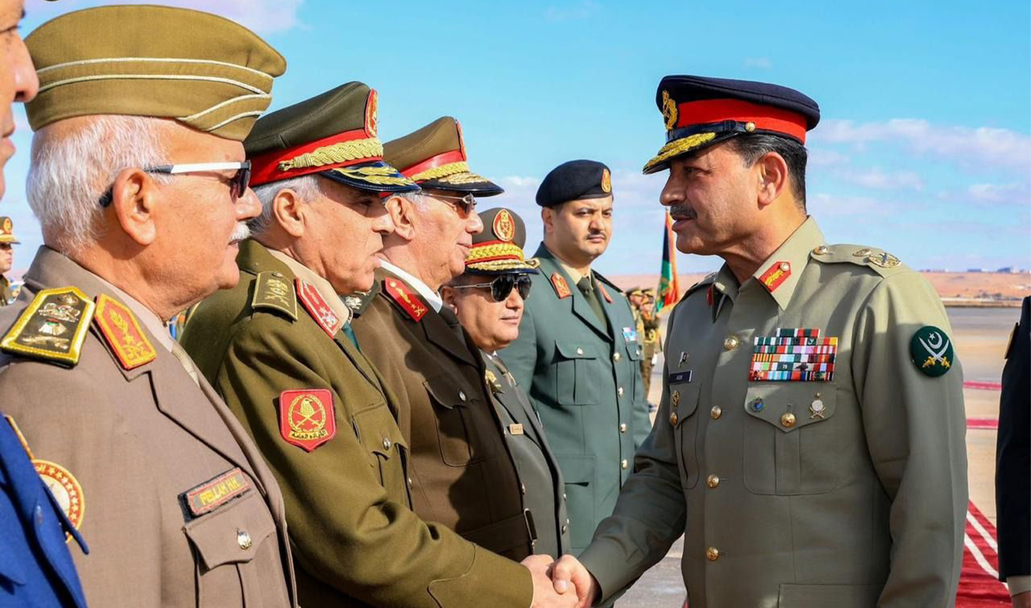 The picture released by Pakistan Army on December 18, 2025, shows Pakistan’s Chief of Army Staff Field Marshal Asim Munir (right) meeting Libyan military commanders during the visit to Libya. (Pakistan Army)