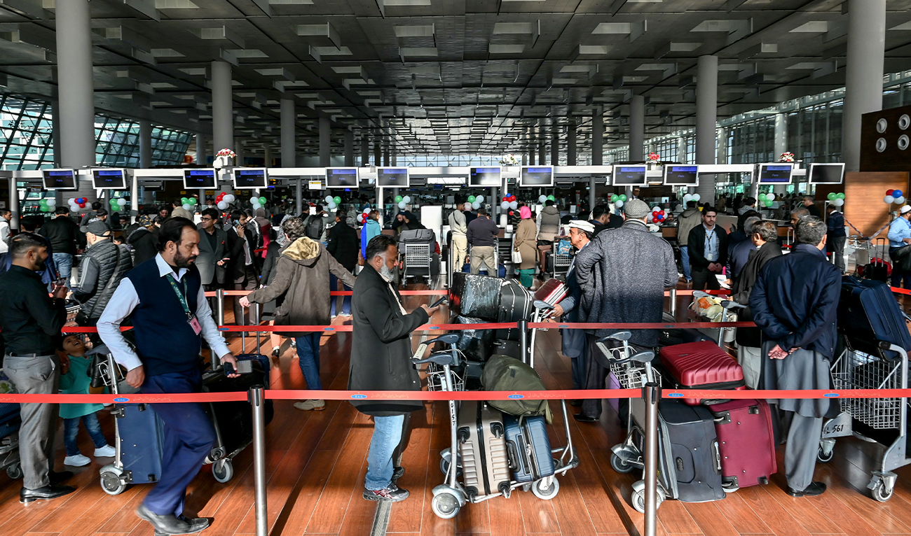 Passengers wait at the immigration counter before boarding their Pakistan International Airlines (PIA) flight to Paris at the Islamabad International Airport on January 10, 2025. (AFP/ file)