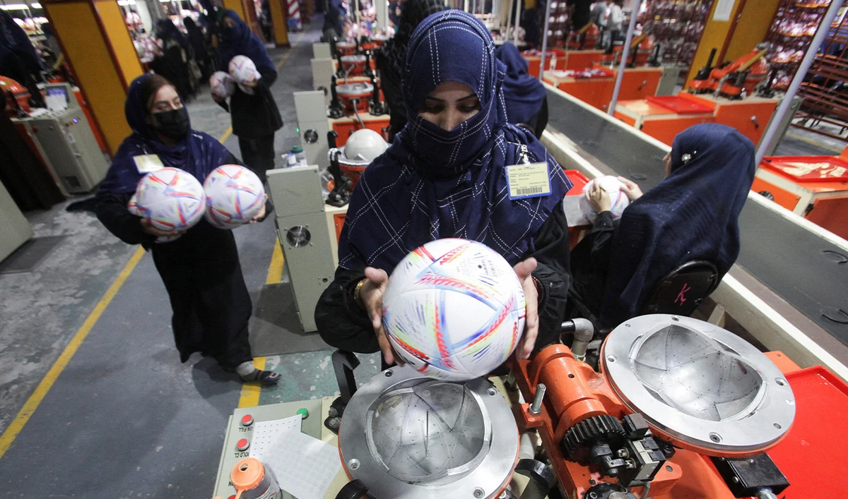 Workers conduct the final check of balls inside the soccer ball factory in Sialkot, Pakistan December 2, 2022. (Reuters/File)