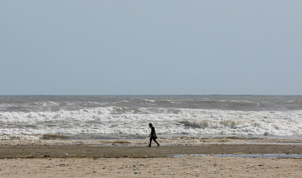 A man walks along Clifton beach in Karachi, Pakistan, on June 12, 2023. (REUTERS/File)