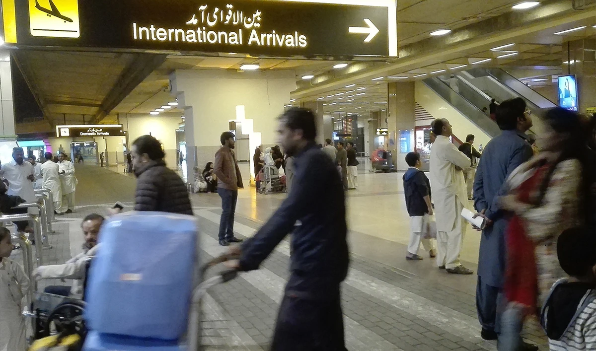 Passengers walk after their arrival at the Jinnah International Airport in Karachi on January 31, 2020. (AFP/ file)