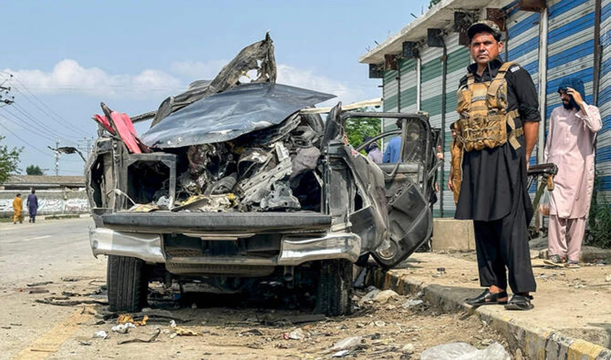 A security personnel stands guard beside the wreckage of a vehicle after a blast in Bajaur district of Khyber Pakhtunkhwa province, Pakistan, on July 2, 2025. (AFP/File)