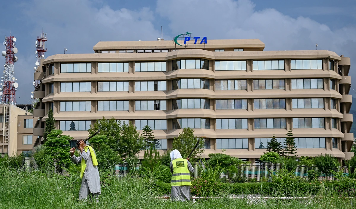 People work near the Pakistan Telecommunication Authority (PTA) headquarters building in Islamabad on August 16, 2024. (AFP/ File)