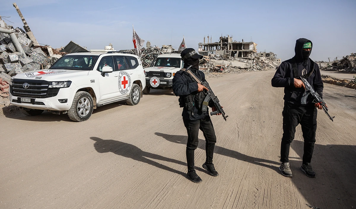 Palestinian Hamas gunmen secure the area as Egyptian workers accompanied by members of the International Committee of the Red Cross (ICRC) search for the remains of the last Israeli hostage in the Zeitoun neighbourhood of Gaza City on December 8, 2025. (AFP/ file)