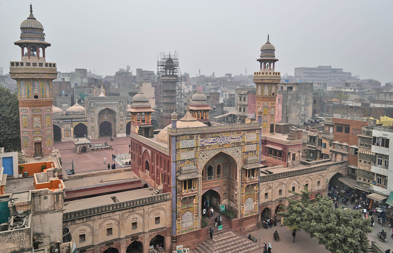 People enter in historical the Wazir Khan mosque at in old neighborhood of Lahore, Pakistan, on December 13, 2025 (AP)