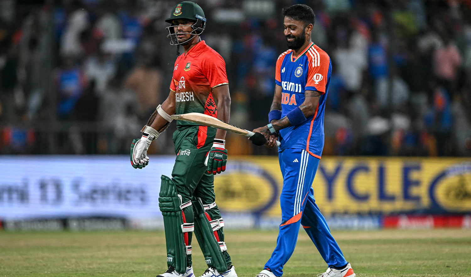 India's Hardik Pandya checks the bat of Bangladesh's Mustafizur Rahman (L) during the first Twenty20 cricket match between India and Bangladesh at the Shrimant Madhavrao Scindia Cricket Stadium in Gwalior on October 6, 2024. (AFP/File)