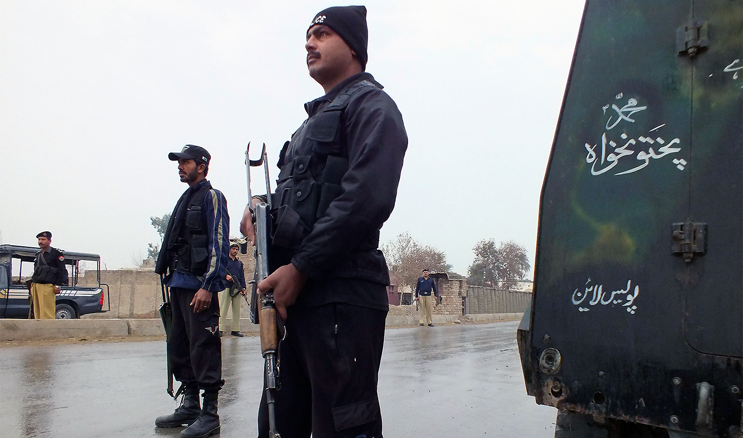 Policemen stand guard as they cordon the road leading to an isolated army checkpoint after it was attacked by militants at Lakki Marwat in the outskirts of Dera Ismail Khan February 2, 2013. (Reuters/File)
