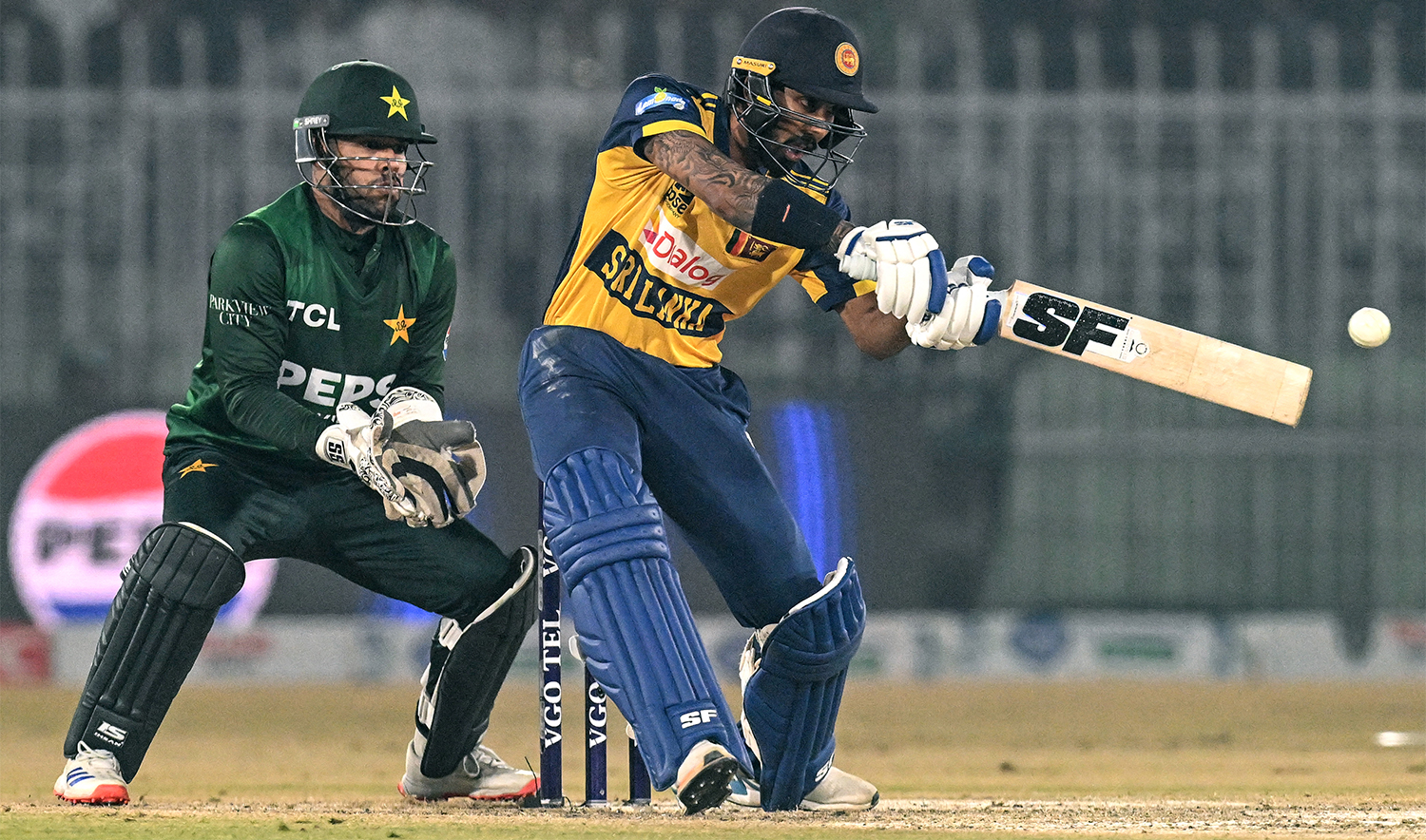 Sri Lanka's Kamil Mishara (R) plays a shot during the Twenty20 international Tri-Series final cricket match between Pakistan and Sri Lanka at the Rawalpindi Cricket Stadium in Rawalpindi on November 29, 2025. (AFP/File)