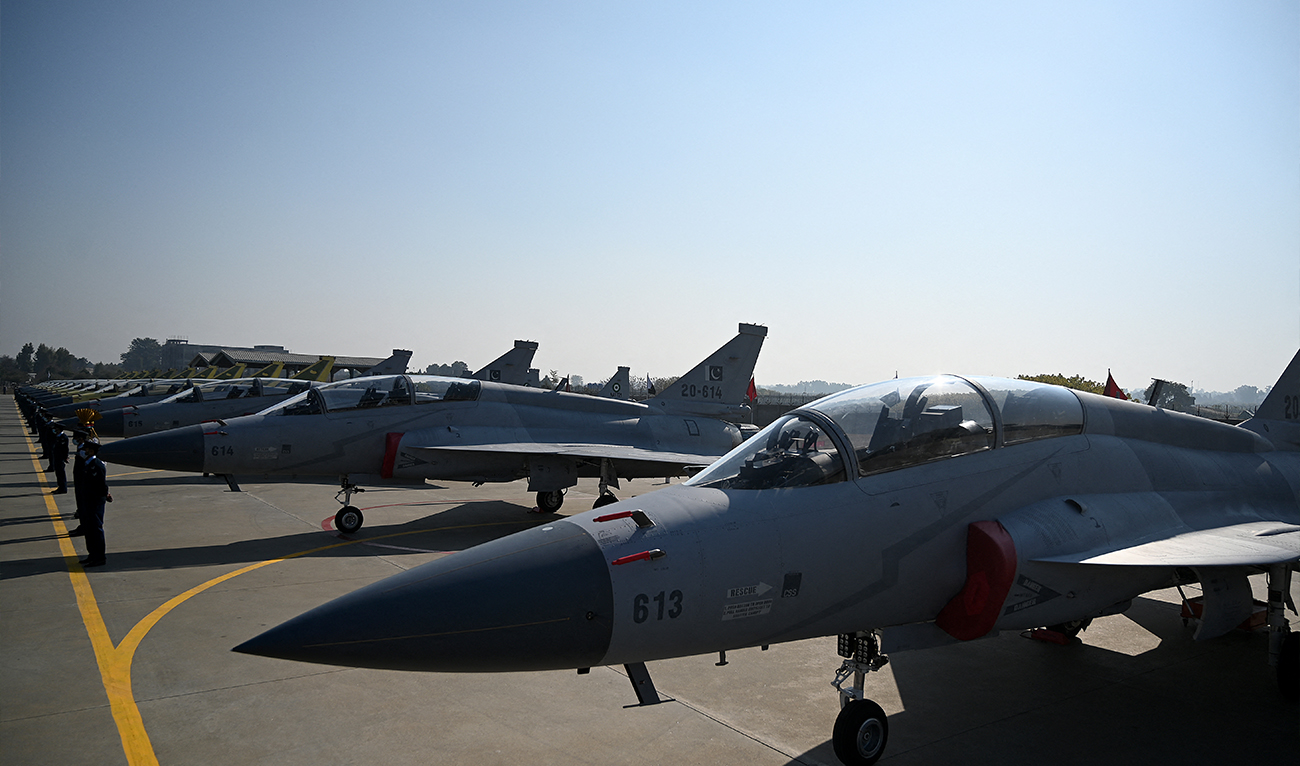 Pakistani Air Force personnel stand guard in front of fourteen Dual-seat JF-17B multi-role aircraft rolled out at a ceremony which coincided with the launch of JF-17 Block-III aircraft at the Pakistan Aeronautical Complex in Kamra, west of the capital Islamabad on December 30, 2020. (AFP/ file)