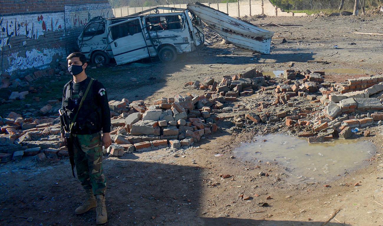 A security personnel stands guard near a detonated explosive-laden van at an army compound in Bannu on March 5, 2025. (AFP/ file)