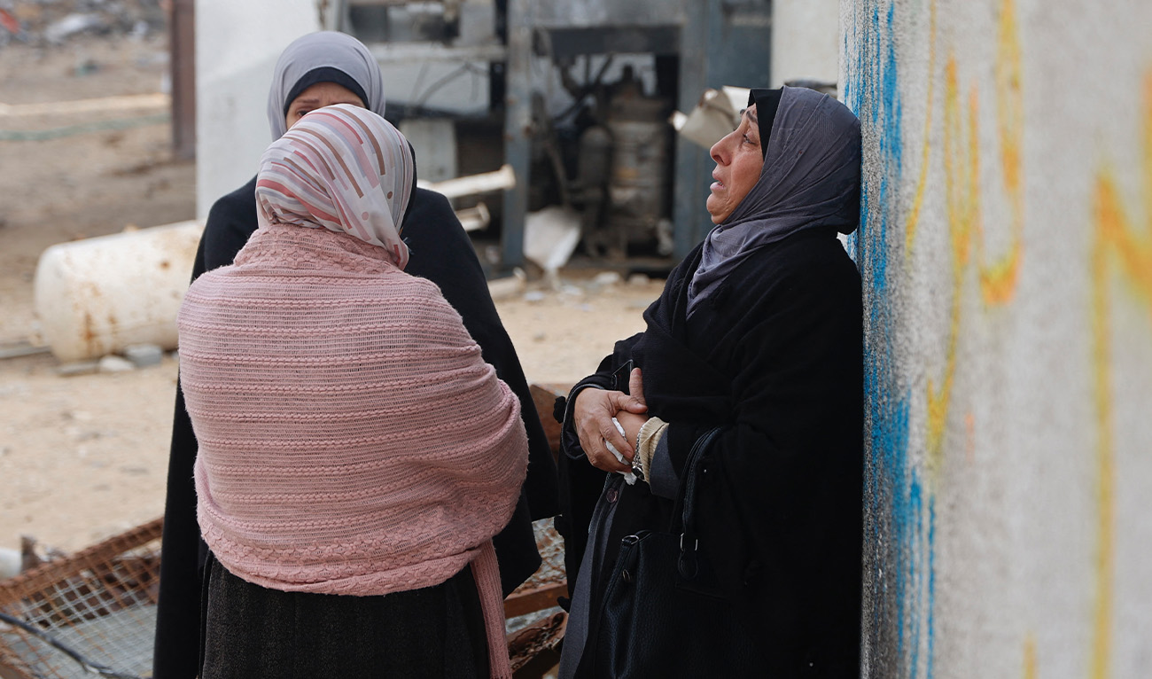 Palestinian women mourn during the funeral of three displaced members of the Hamoda family who died after parts of a war-damaged building where they had taken shelter collapsed on a windy winter day in Gaza City on January 13, 2026. (AFP/File)