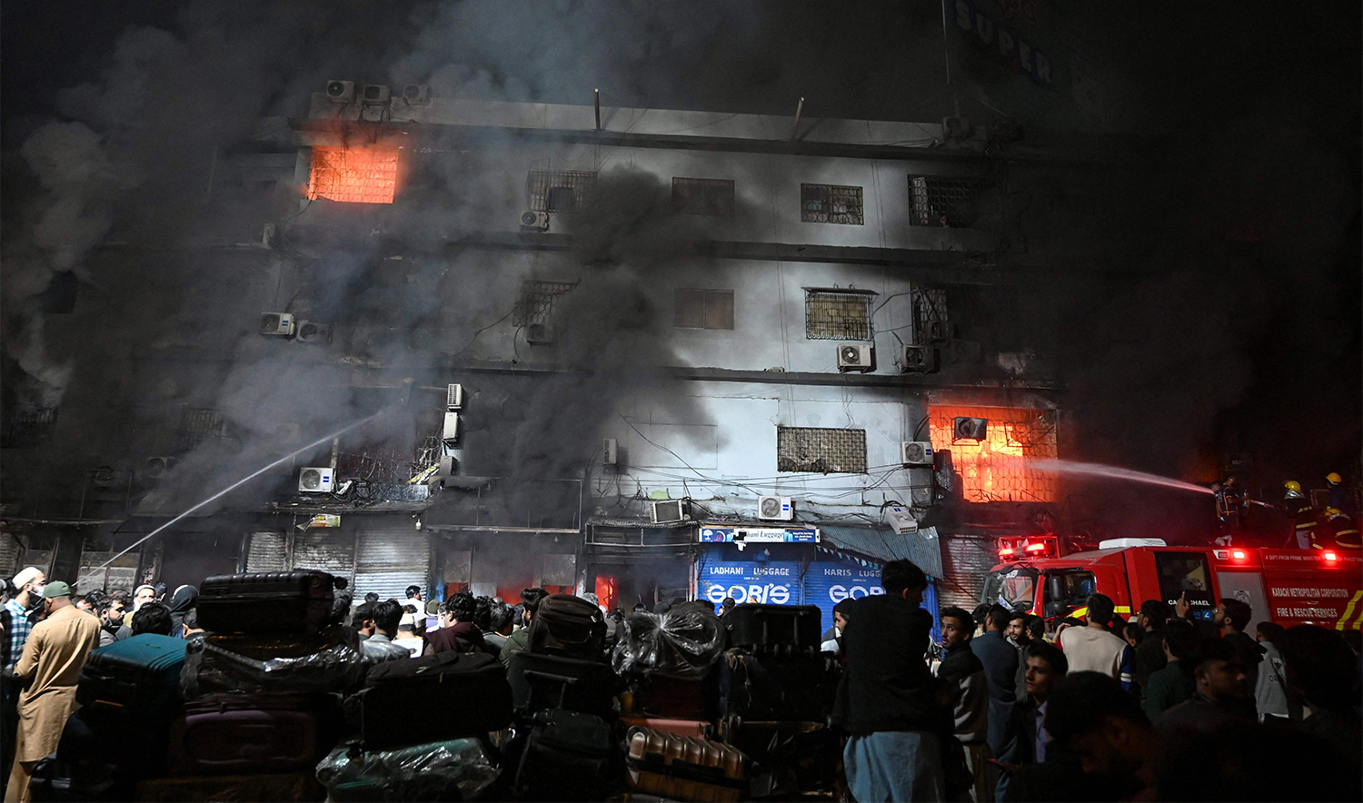 Firefighters douse a fire that broke out at a shopping mall in Karachi on January 18, 2026. (AFP)