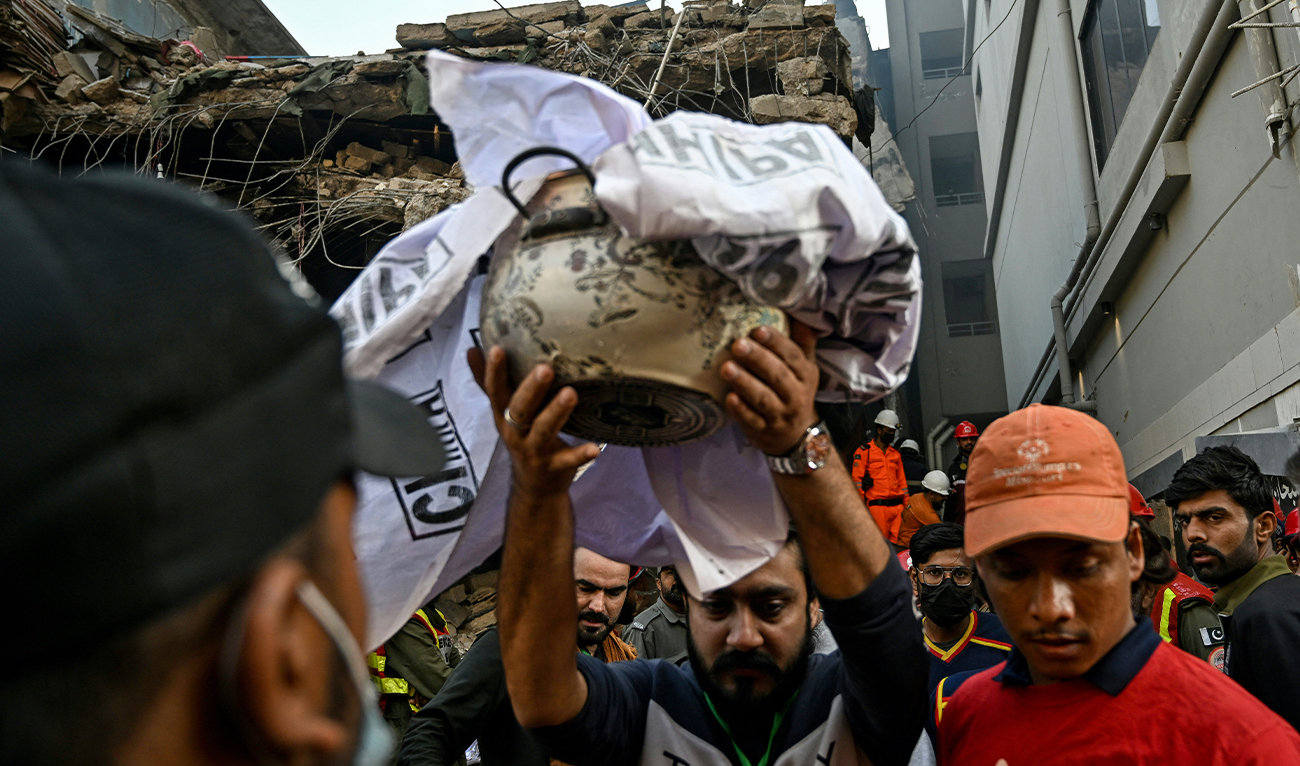 Rescue workers extract remains of a victim after a massive fire broke out at a shopping mall in Karachi on January 21, 2026. (AFP/File)
