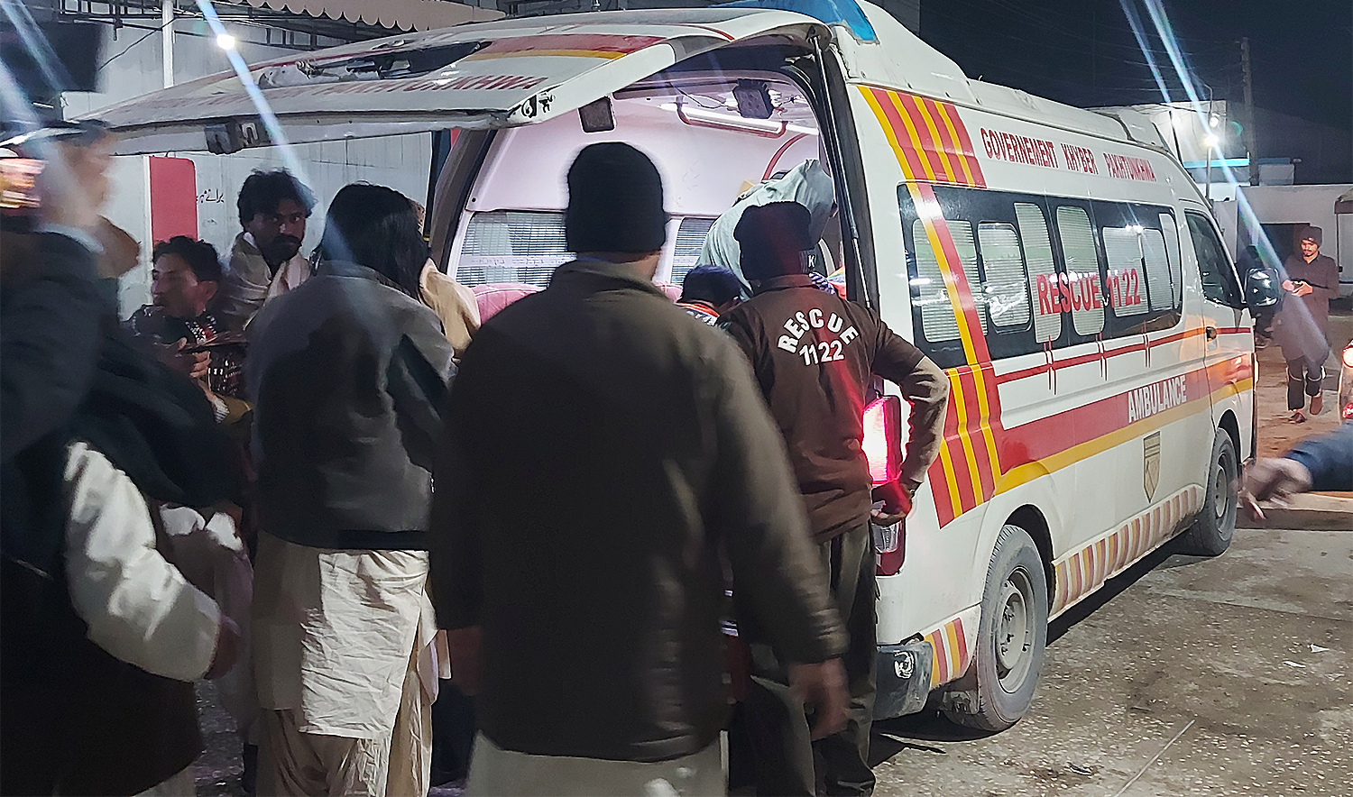 Rescue workers approach an ambulance arrive with the injured victims of suicide bombing at a wedding ceremony, at a hospital in Dera Ismail Khan, Pakistan, on January 23, 2026. (AP)