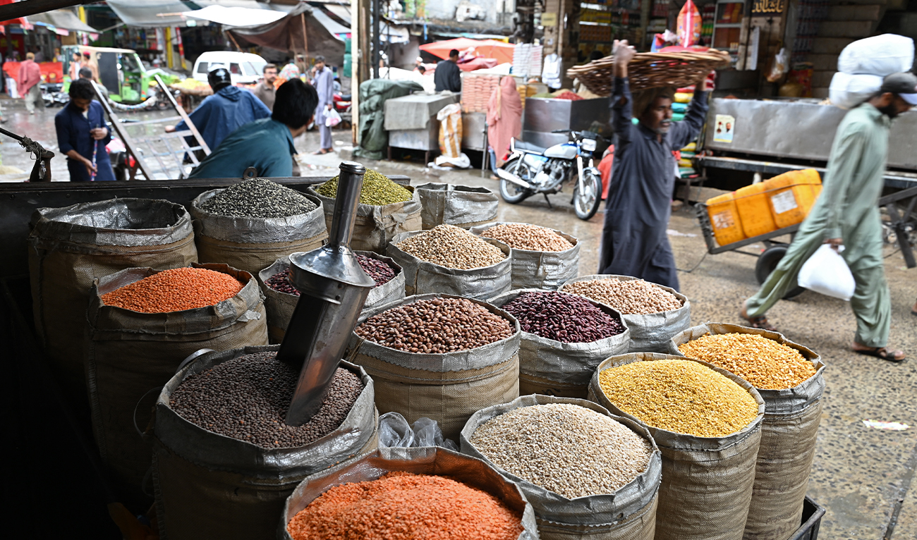 A shopkeeper selling pulses waits for customers at a market in Rawalpindi on June 1, 2023. (AFP/File)