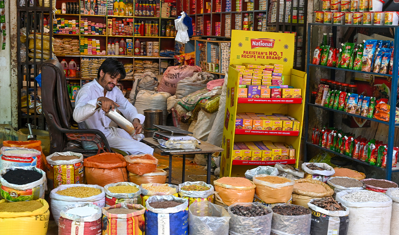 A shopkeeper sells spices at a market in Lahore on June 10, 2025. (AFP/ file)