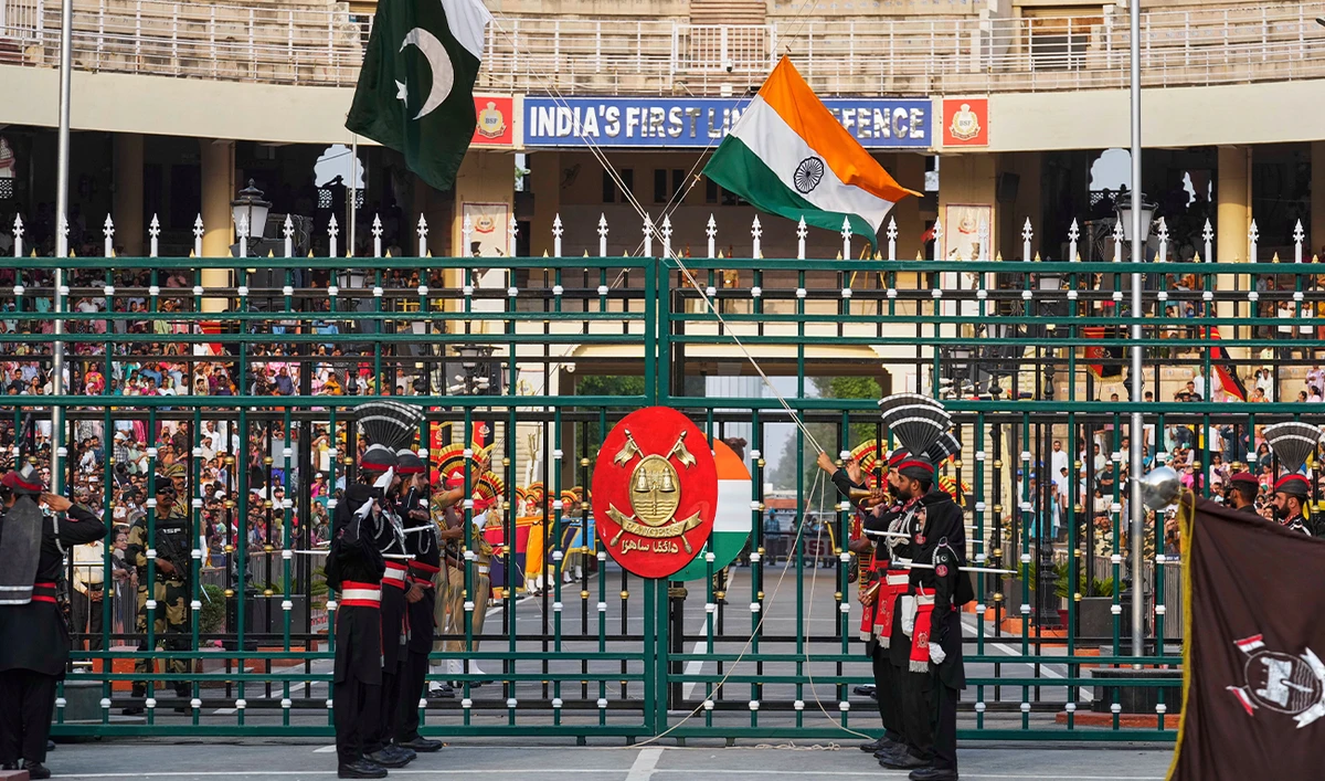 Pakistan’s Rangers soldiers, in black, and Indian Border Security Forces soldiers, lower their flags during a daily closing ceremony at the Wagah border near Lahore, Pakistan, on May 3, 2025. (AP/File)